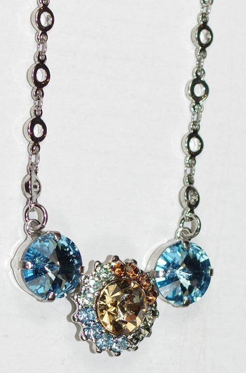 MARIANA PENDANT FORGET ME NOT: blue, amberm green, brown stones in 1.75" silver rodium setting, 18" adjustable chain