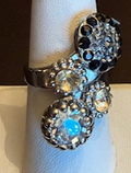 MARIANA RING BLACK ORCHID: black, amber, grey, clear stones in 1" silver rhodium setting, adjustable size band