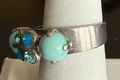 MARIANA RING ZAMBEZI: blue stones, center stone = 3/8" in silver setting, adjustable size band