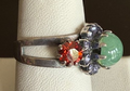MARIANA RING IMAGINE: orange, pacific opal, purple stones, center stone = 1/2" in silver setting, adjustable size band