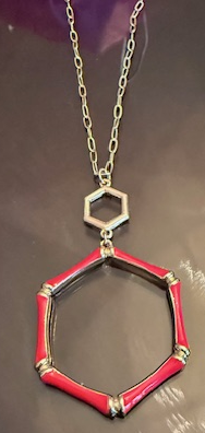 HEXAGON RED PENDANT IN GOLDTONE CHAIN.