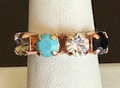 MARIANA RING ZANZIBAR: blue, black, clear, taupe 1/4" stones in rose gold setting, adjustable size band