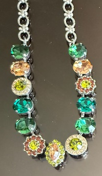 MARIANA NECKLACE EVERGREEN: green, amber, brown, teal 1/2" oval stones in silver rhodium setting, 21" adjustable chain