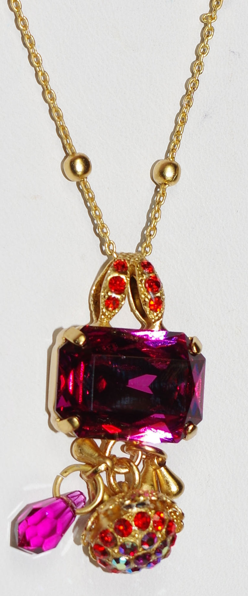 MARIANA PENDANT LADY MARMALADE: pink, orange stones in 1.5" yellow gold setting, 28" adjustable chain