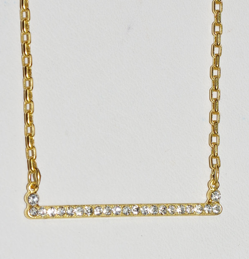 MARIANA PENDANT ON A CLEAR DAY: clear stones in 1.5" yellow gold setting, 18" adjustable chain