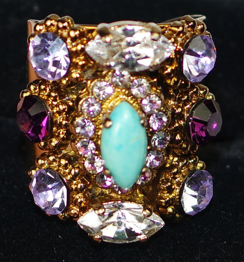 MARIANA RING: purple, blue, clear stones in 1" wide european gold setting, adjustable size band