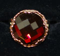MARIANA RING RED: dark red stone in 3/4" rose gold setting, adjustable size band