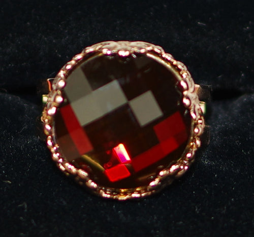 MARIANA RING RED: dark red stone in 3/4" rose gold setting, adjustable size band