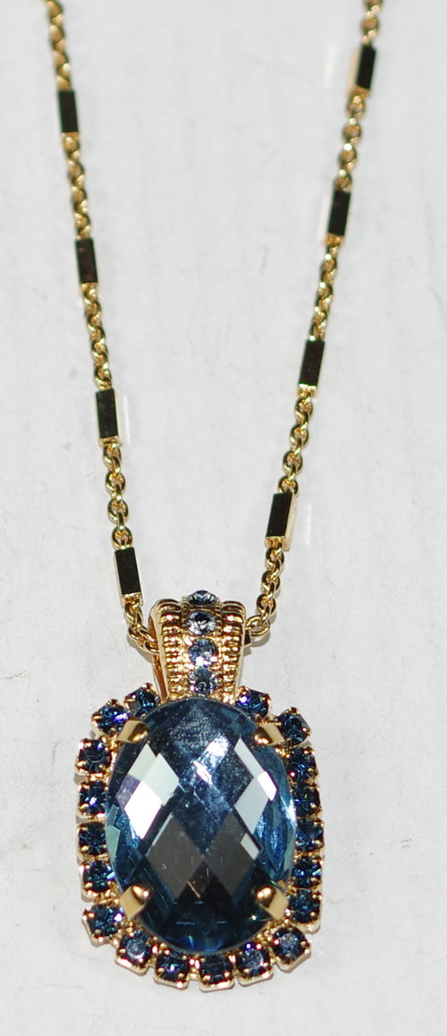 MARIANA PENDANT: blue stones in 1" pendant, yellow gold setting, 32" adjustable chain