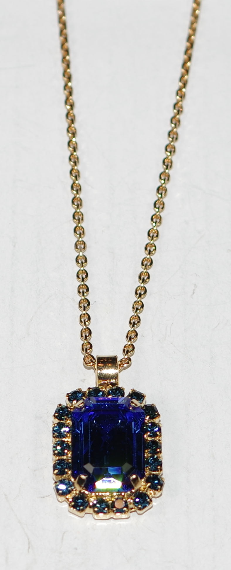 MARIANA PENDANT FAIRYTALE: blue stones in 1" yellow gold setting, 19" adjustable chain