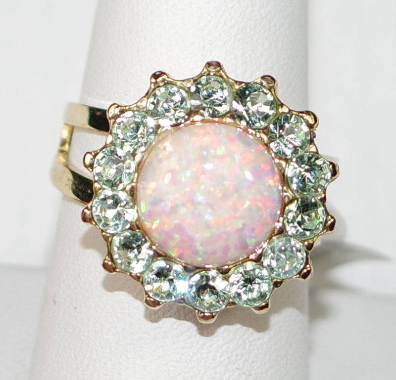 MARIANA RING ENCHANTED: cream simulated opal, green stones in 3/4" yellow gold setting, adjustable size band